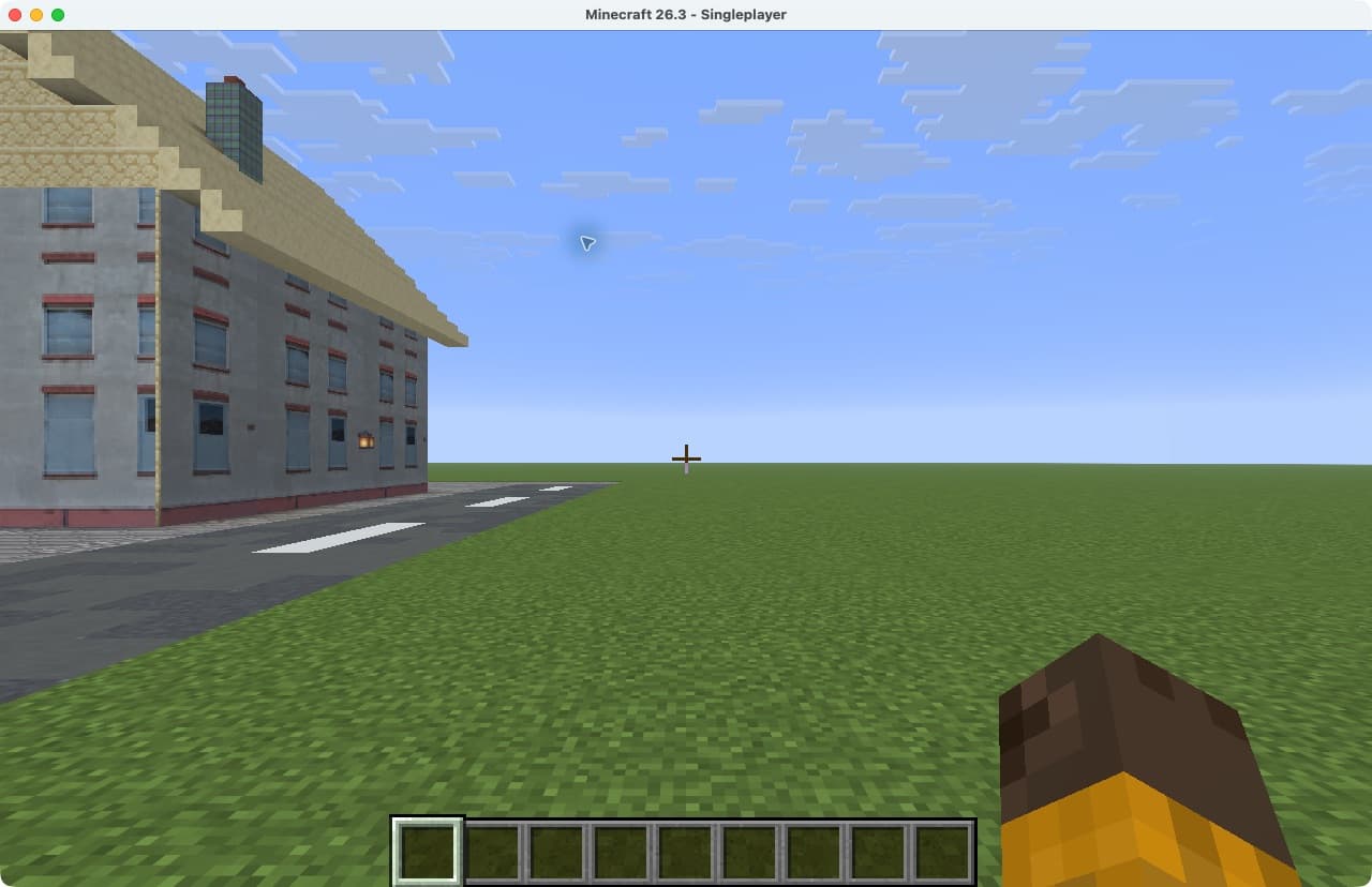 A small locally generated MapMC world showing a textured building and road after saving and reopening in Minecraft Java 26.3
